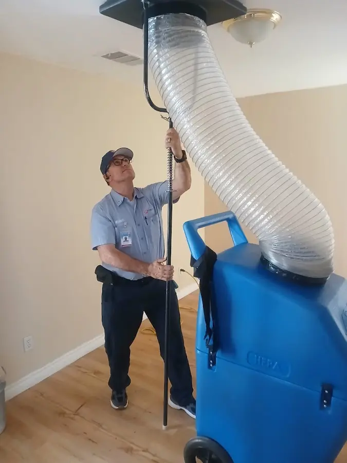 Furnace Tune-Up technician using HEPA equipment in Haslet